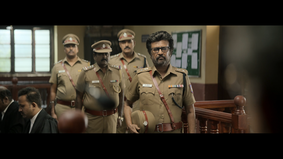 Four khaki-clad police officers stand at attention.