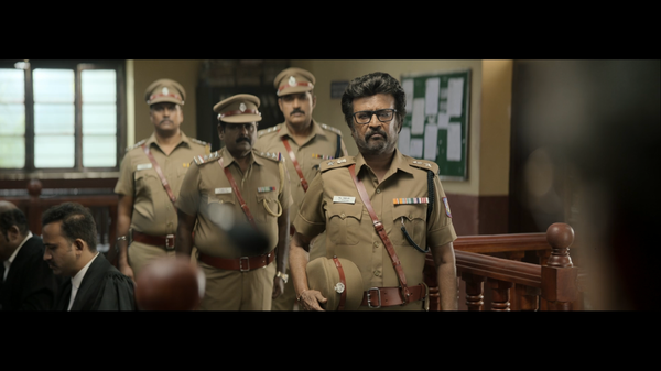 Four khaki-clad police officers stand at attention.