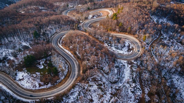 scenic snowy mountain road with hairpin turns